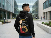 Black anime pirate hoodie back print in outdoor campus walkway scene