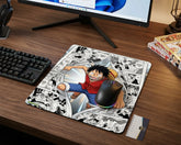 Anime gaming mouse pad featuring Monkey D. Luffy breaking through manga panels on modern wooden gaming desk