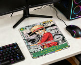 Anime gaming mouse pad featuring Monkey D. Luffy card artwork on RGB gaming desk with mechanical keyboard and gaming mouse
