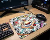Large Gear 5 Luffy anime desk mat featuring colorful manga panel design beside RGB gaming mouse and keyboard