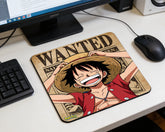 Monkey D. Luffy smiling anime mouse pad with wanted poster background beside computer monitor and mouse