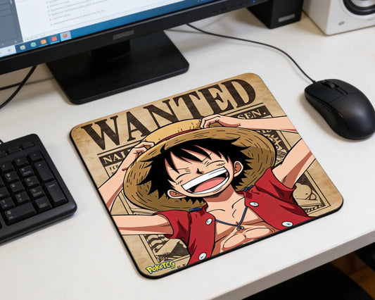 Monkey D. Luffy smiling anime mouse pad with wanted poster background beside computer monitor and mouse