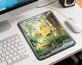 Cute Pikachu EX anime mouse pad featuring forest artwork placed on modern white desktop setup with keyboard and mouse