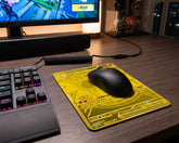Yellow Mega Charizard EX inspired anime mouse pad in RGB gaming setup with compact keyboard and black gaming mouse