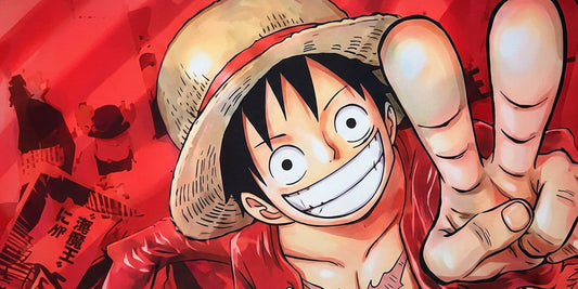 Close-up of Monkey D. Luffy from One Piece smiling and pointing, printed on vibrant red anime desk mat.