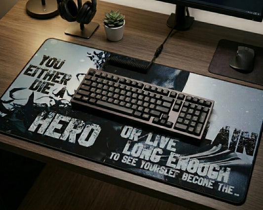 Dark aesthetic anime desk mat with motivational typography and monochrome artwork on a wooden gaming desk setup with mechanical keyboard, headphones, and monitor