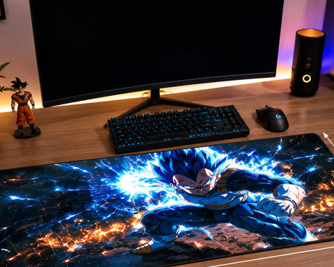 A large desk mat featuring an anime character with blue energy effects, shown on a wooden desk in front of a computer monitor, keyboard, mouse, and speaker.