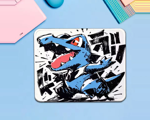 Garchomp Pokémon gaming mouse pad featuring an aggressive blue dragon Pokémon with an open mouth, sharp teeth, red accents, and bold black-and-white comic-style action artwork.
