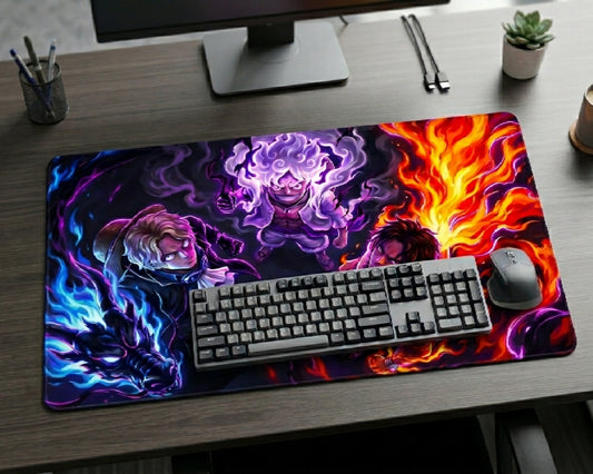 Colorful Gear 5 Luffy, Ace and Sabo anime desk mat with glowing fire and aura effects alongside One Piece characters on a premium gaming desk with keyboard and wireless mouse