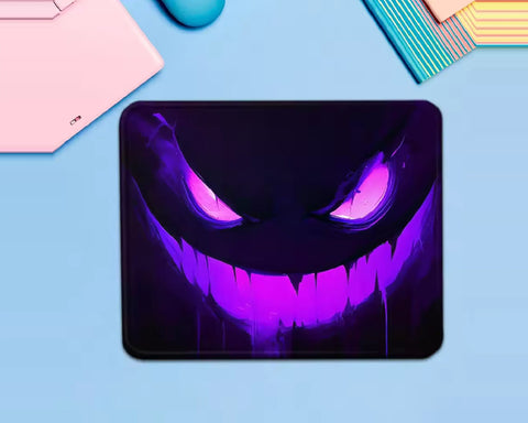 Gengar Pokémon gaming mouse pad featuring a dark ghost face with glowing pink eyes, a bright neon-purple grin, and a black and violet background.