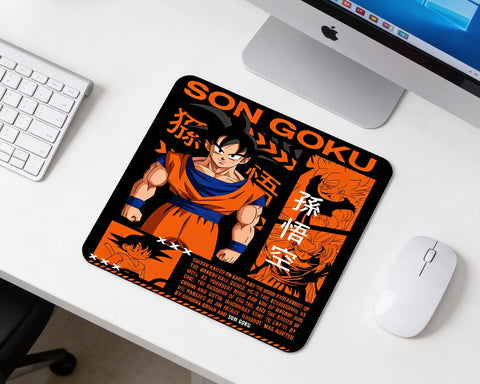 Dragon Ball Son Goku themed gaming mouse pad with orange Japanese graphic design beside keyboard and mouse