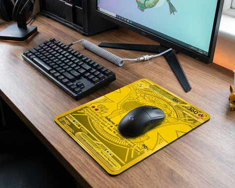 Golden Mega Charizard EX Pokémon mouse pad placed on wooden gaming desk with mechanical keyboard and wireless gaming mouse