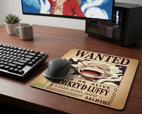 Large Monkey D. Luffy wanted poster desk mat with anime-inspired design on modern wooden gaming setup