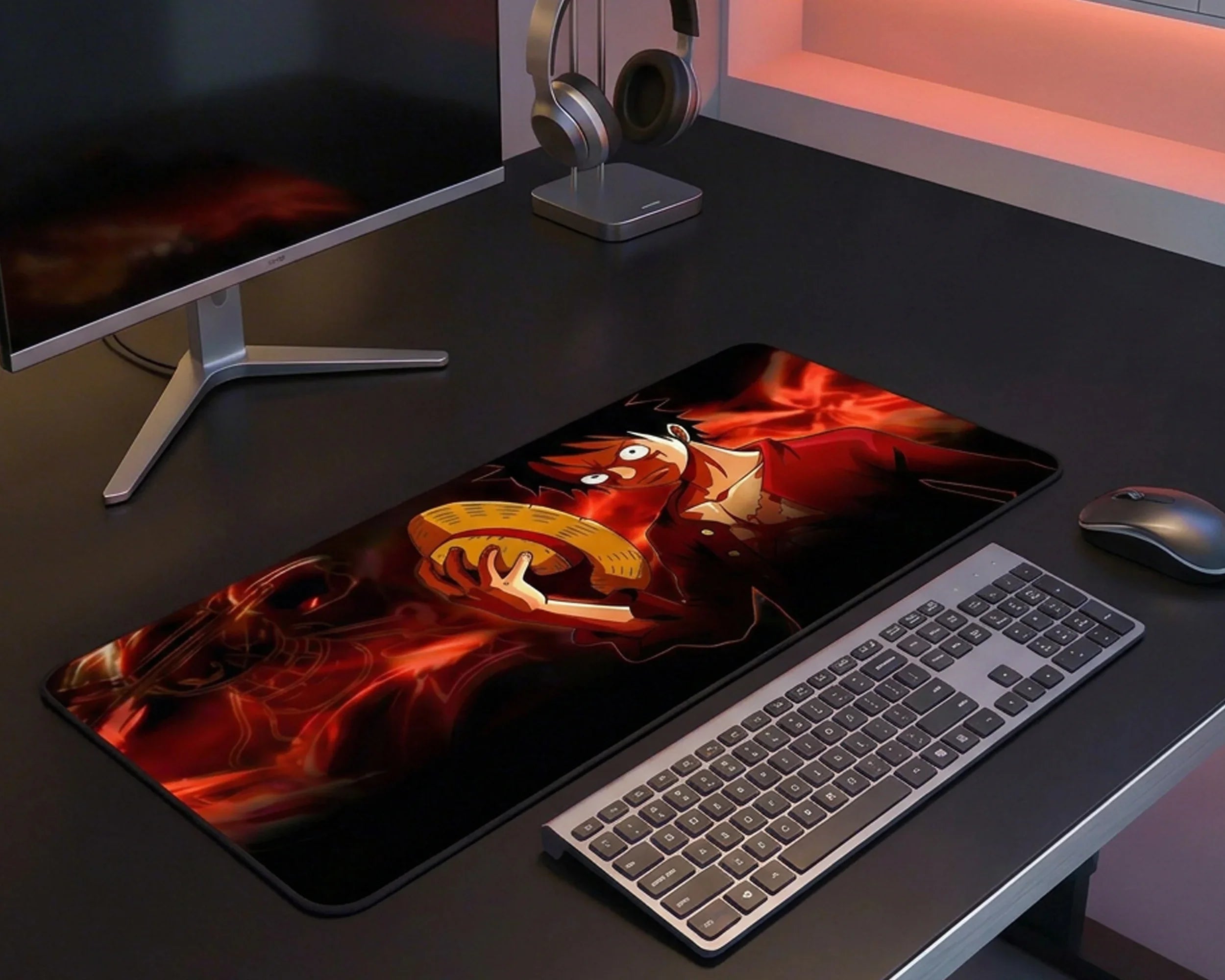 Modern workspace with large anime desk mat, keyboard, mouse, and headphones in a minimalist setup.