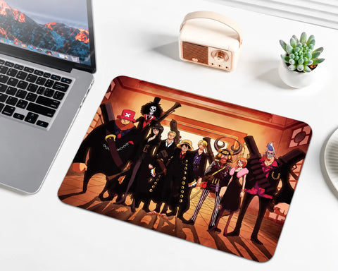 One Piece Straw Hat Pirates crew standing together in coordinated outfits inside a warmly lit wooden ship interior, featuring Luffy, Zoro, Nami, Sanji, Chopper, Robin, Usopp, Franky, and Brook on an anime gaming mouse pad.
