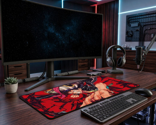 Modern RGB gaming setup featuring large One Piece anime desk mat with Luffy design, widescreen monitor, keyboard, mouse, and streaming microphone.