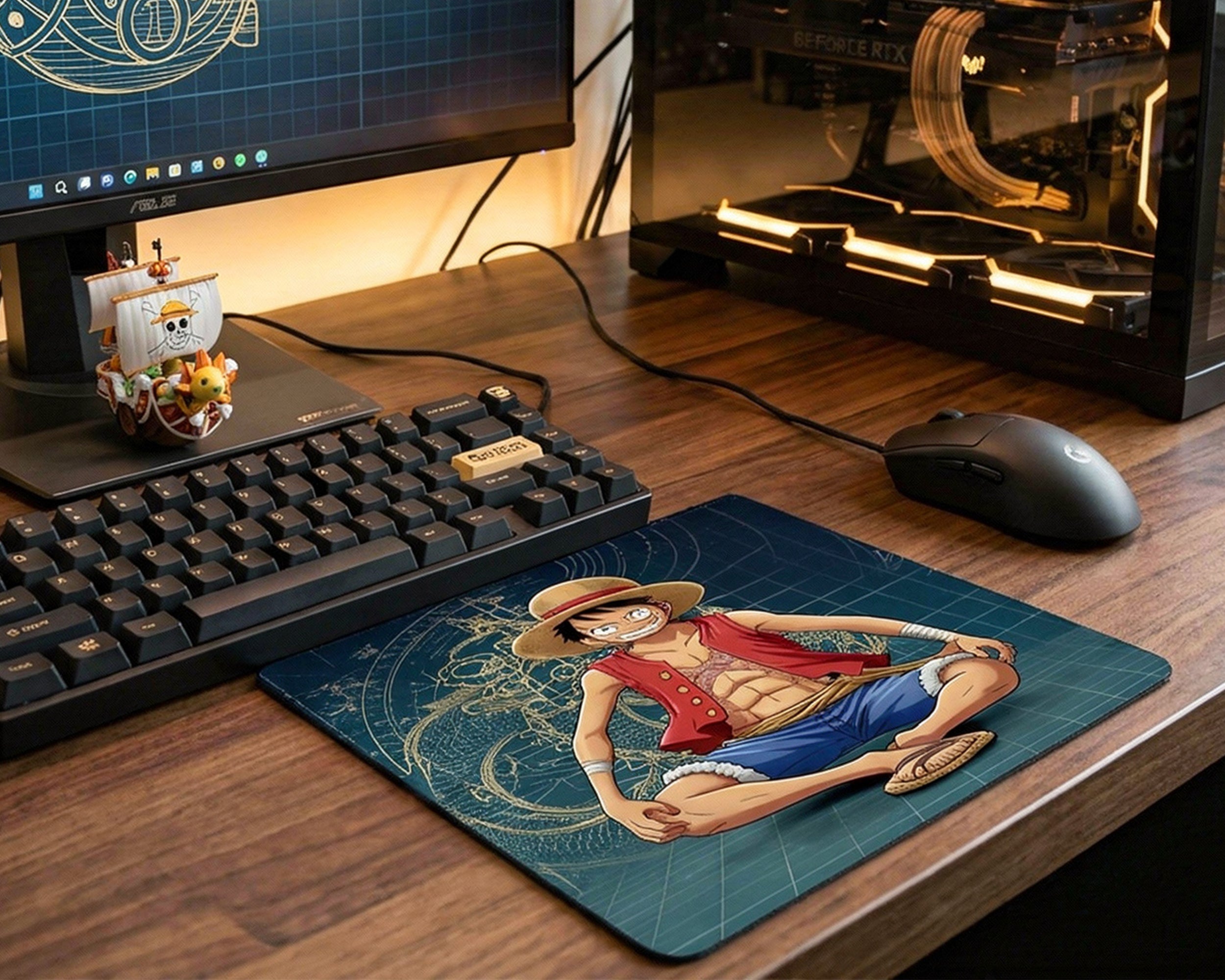 One Piece Luffy anime mouse pad placed on wooden gaming desk beside mechanical keyboard and gaming PC setup