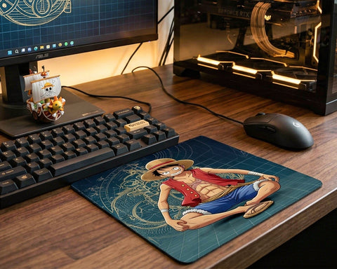One Piece Luffy anime mouse pad placed on wooden gaming desk beside mechanical keyboard and gaming PC setup