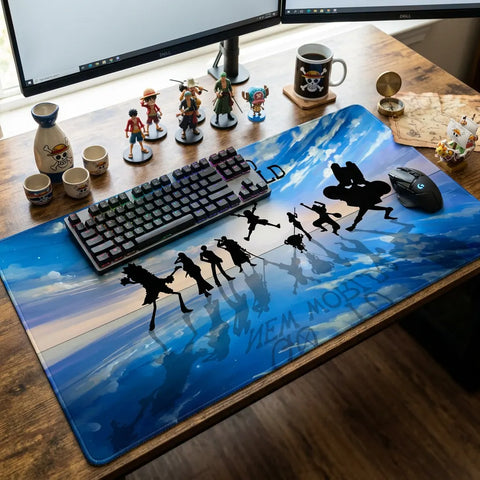 One Piece themed gaming desk setup with oversized blue sky desk mat, mechanical keyboard, gaming mouse, and anime figurines displayed on wooden desk.