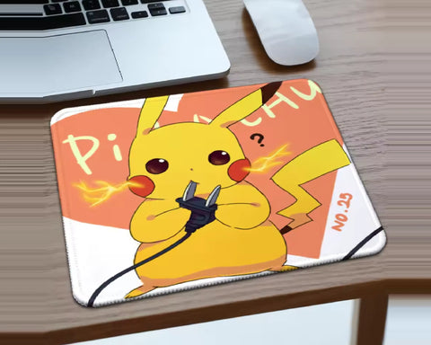 Pikachu Pokémon gaming mouse pad featuring yellow Pikachu holding a black power plug with glowing lightning effects, a coral-orange and white background, and a colorful electric-themed design displayed on a wooden desk.