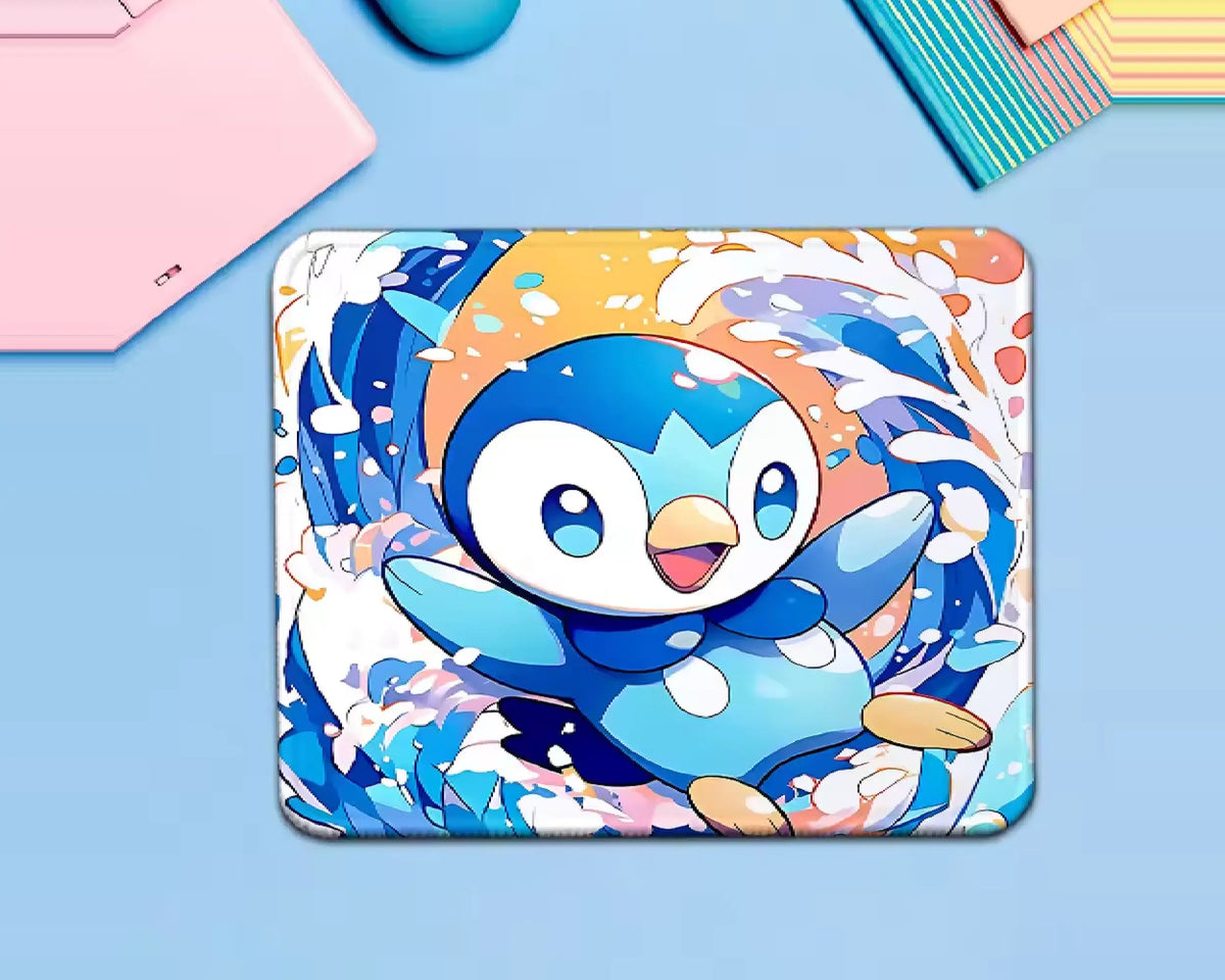 Piplup Pokémon mouse pad featuring a cute blue penguin Pokémon surrounded by dynamic blue water splashes, white accents, and warm orange details.