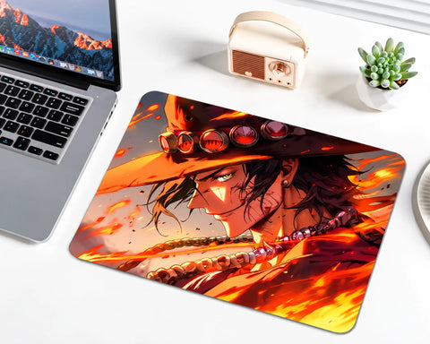 Portgas D. Ace from One Piece wearing his orange wide-brimmed hat with red ornaments, dark hair, and a bead necklace, surrounded by glowing orange flames, golden fire streaks, and a dramatic fiery background on a gaming mouse pad.