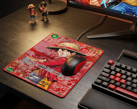 Red Monkey D. Luffy anime mouse pad on dark gaming desk with RGB keyboard and gaming mouse setup