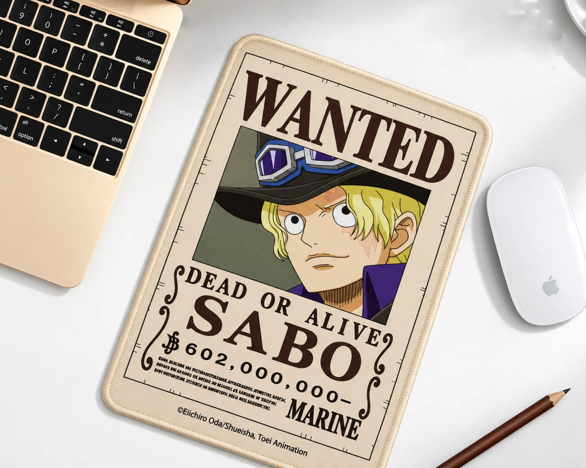 Sabo One Piece gaming mouse pad featuring a vintage Wanted Dead or Alive bounty poster, blonde-haired Sabo wearing goggles, cream background, and dark-brown lettering.