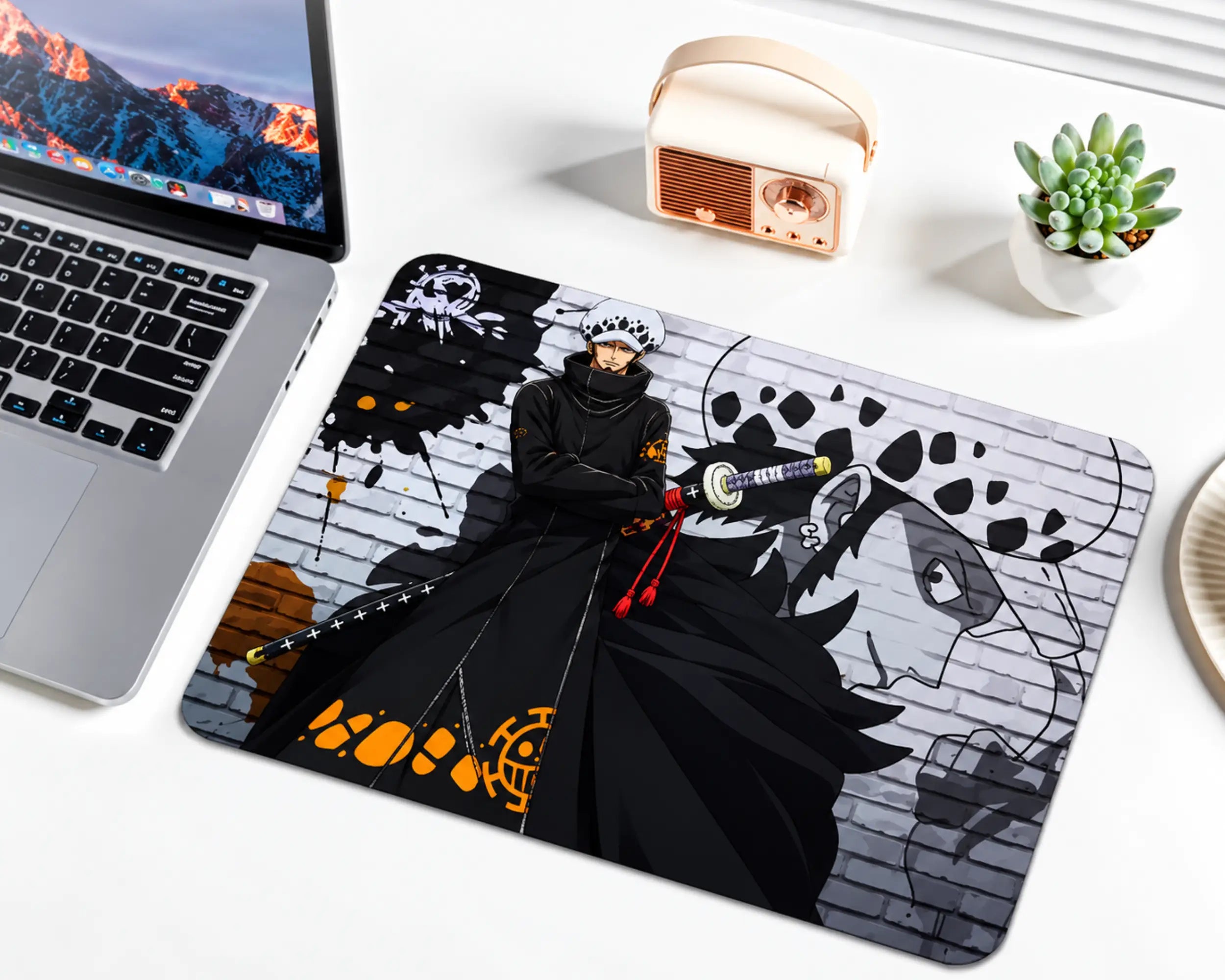 Trafalgar Law One Piece gaming mouse pad featuring his white spotted hat, long black outfit, sword, orange accents, pirate insignia, and monochrome brick wall background.