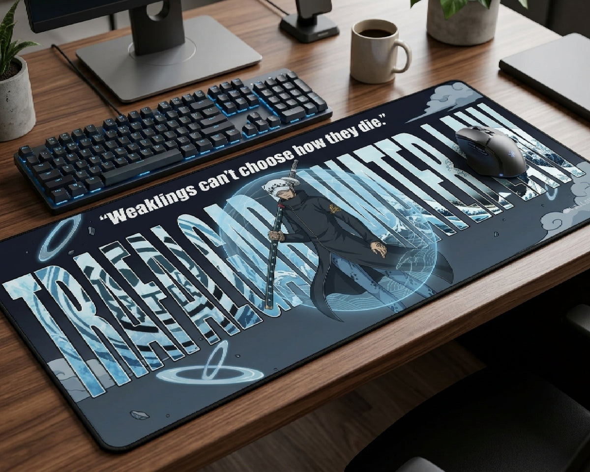 Trafalgar Law One Piece anime desk mat with motivational quote and icy blue artwork displayed on a premium gaming desk setup with RGB keyboard and wireless mouse