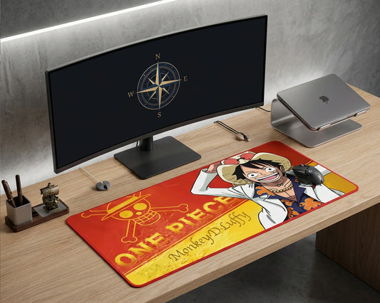 Minimalist desk setup with monitor and keyboard featuring a large anime-themed desk mat with vibrant action artwork.