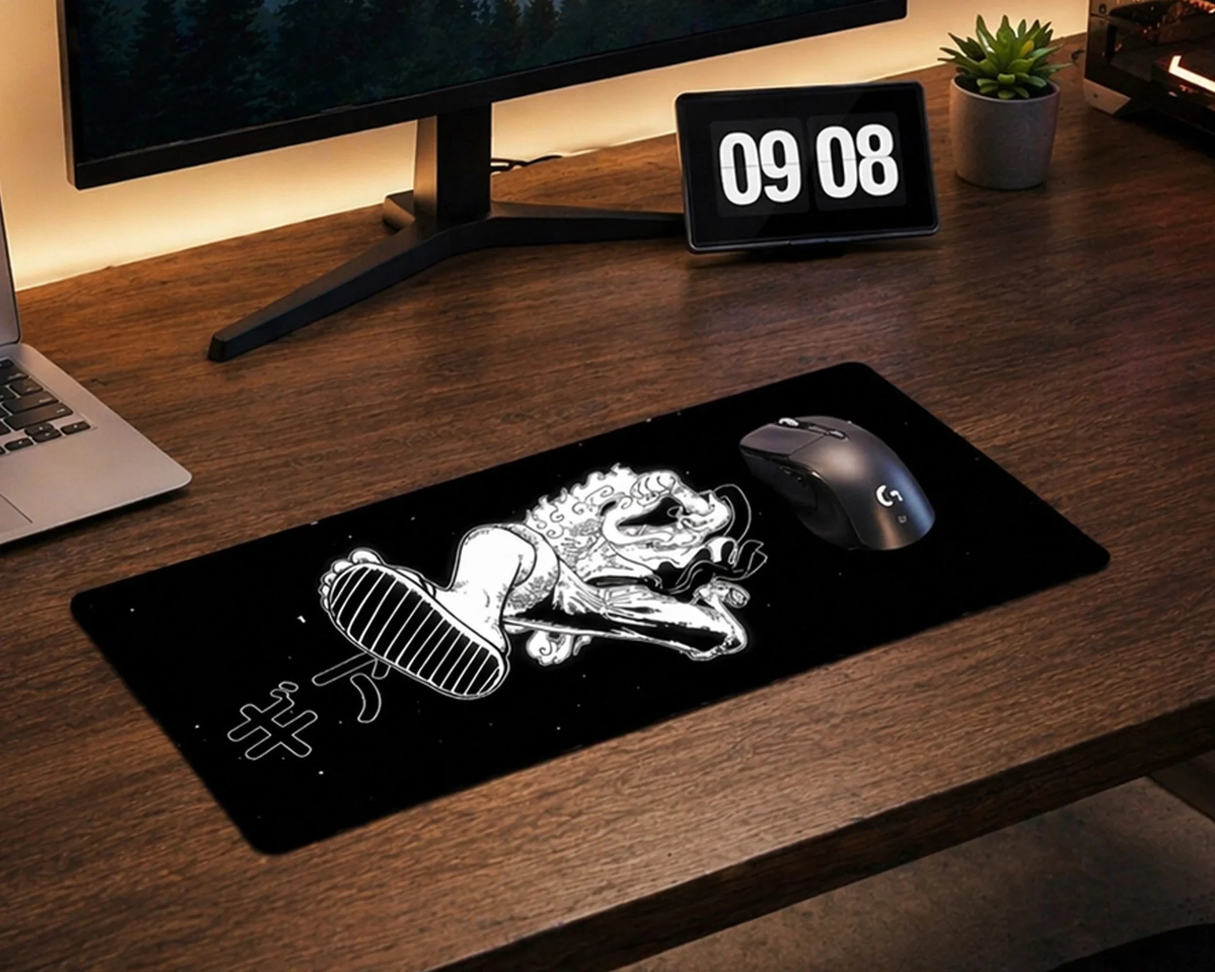 Minimalist gaming desk setup with black anime mouse pad featuring stylized Luffy artwork, mechanical keyboard, monitor, and clean wooden workspace.