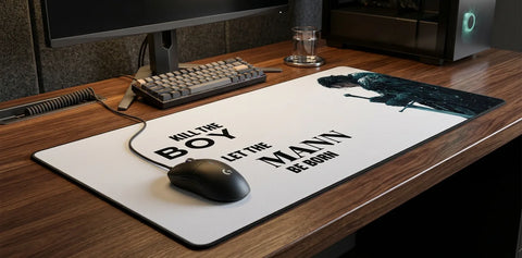 Large extended mouse pad with ‘Kill the boy, let the man be born’ quote, cinematic snowy warrior design on modern desk.