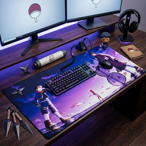 Wide anime desk mat with kid Obito, Rin, and Obito design on a gaming setup with dual monitors, keyboard, and ninja props