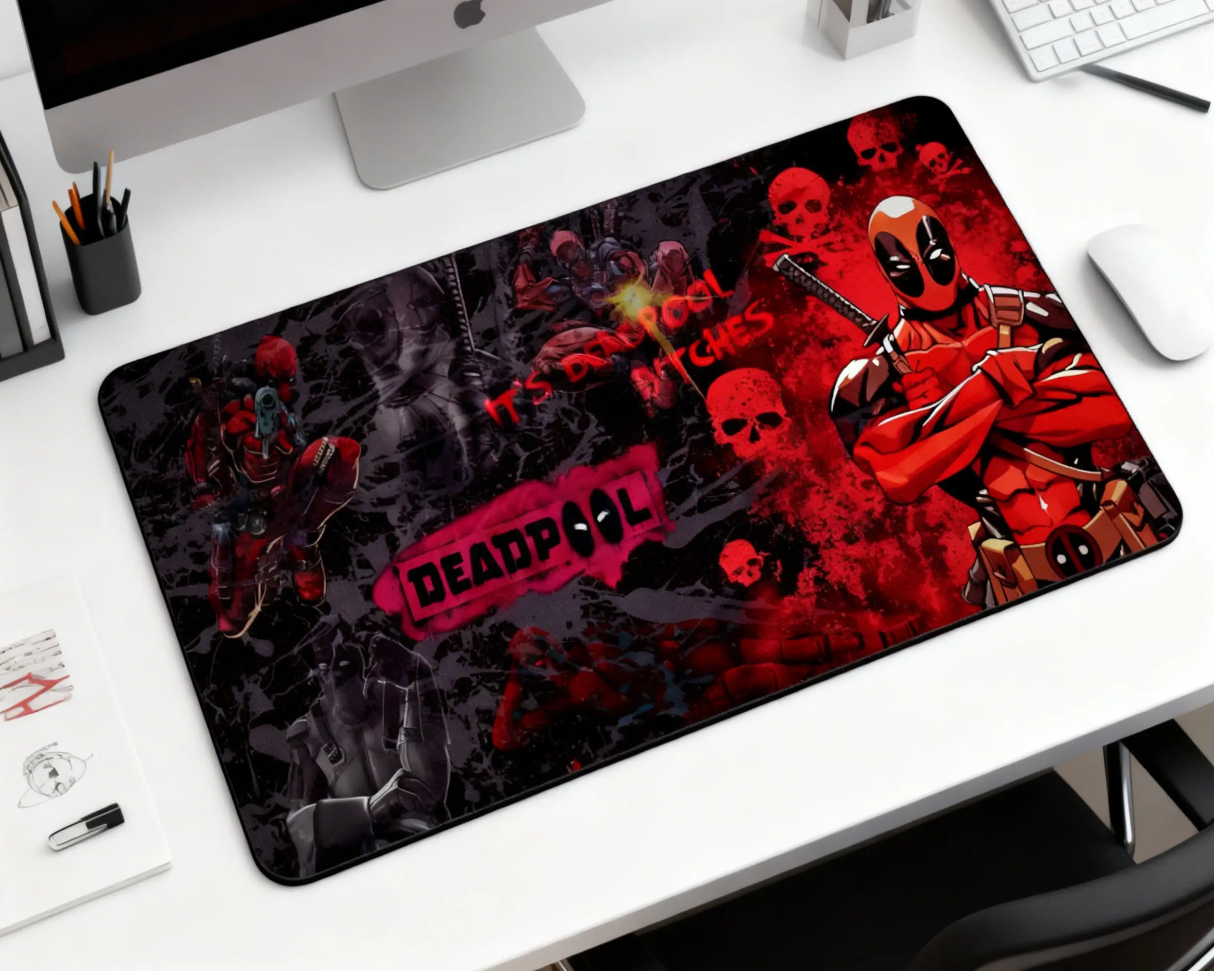 large deadpool gaming mouse pad with red black design on modern desk setup with keyboard and monitor