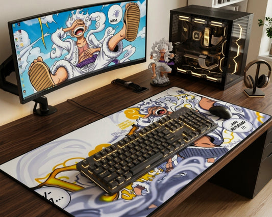 One Piece Gear 5 Luffy desk setup with white anime desk mat, curved monitor, custom PC, gold RGB mechanical keyboard, mouse, figure, and headphones.