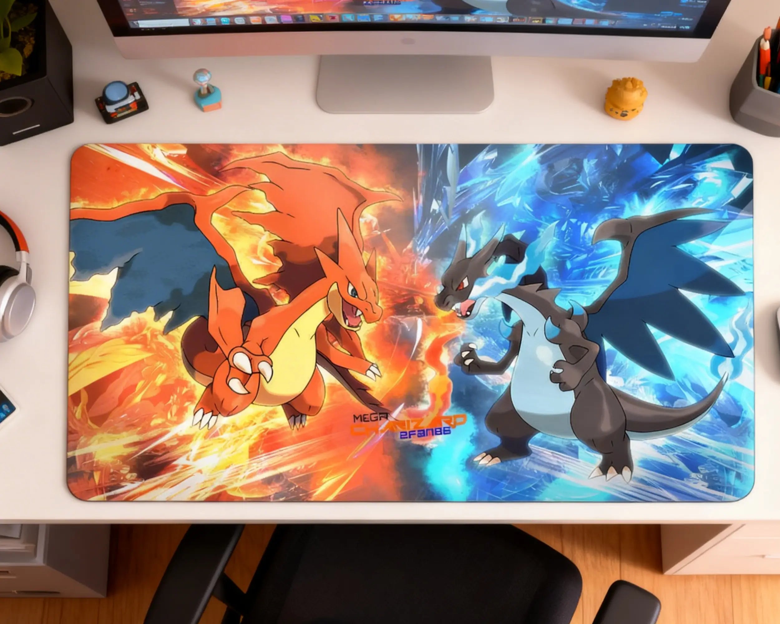 top view of large pokemon desk mat featuring mega charizard x vs y under monitor with accessories